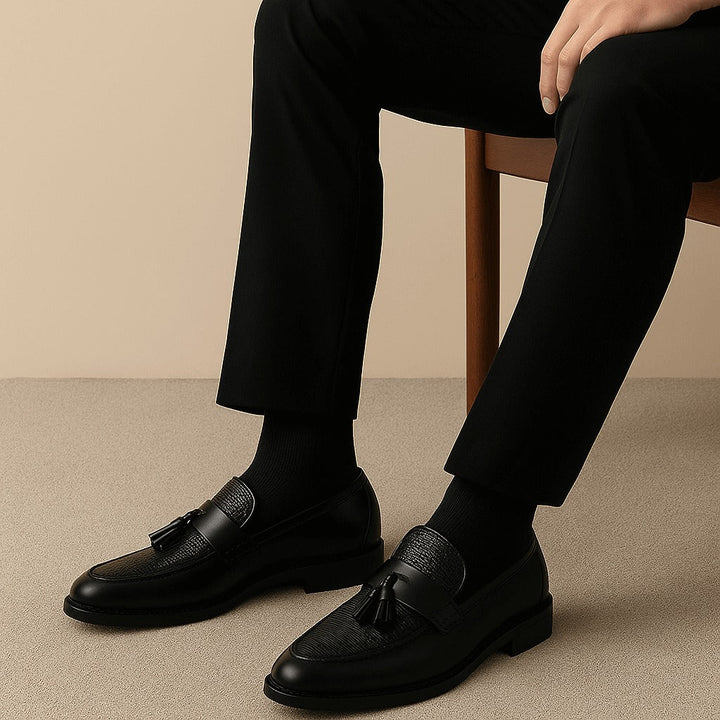 Men's slip-on tassel dress loafers displayed as a matching pair