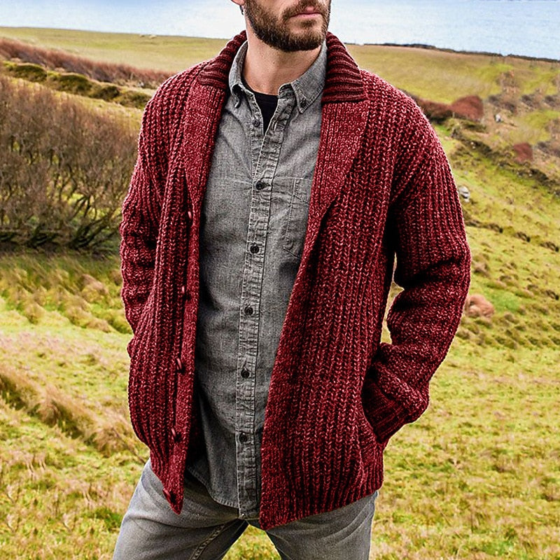 Side view of a men's chunky knit cardigan with a relaxed shawl collar.