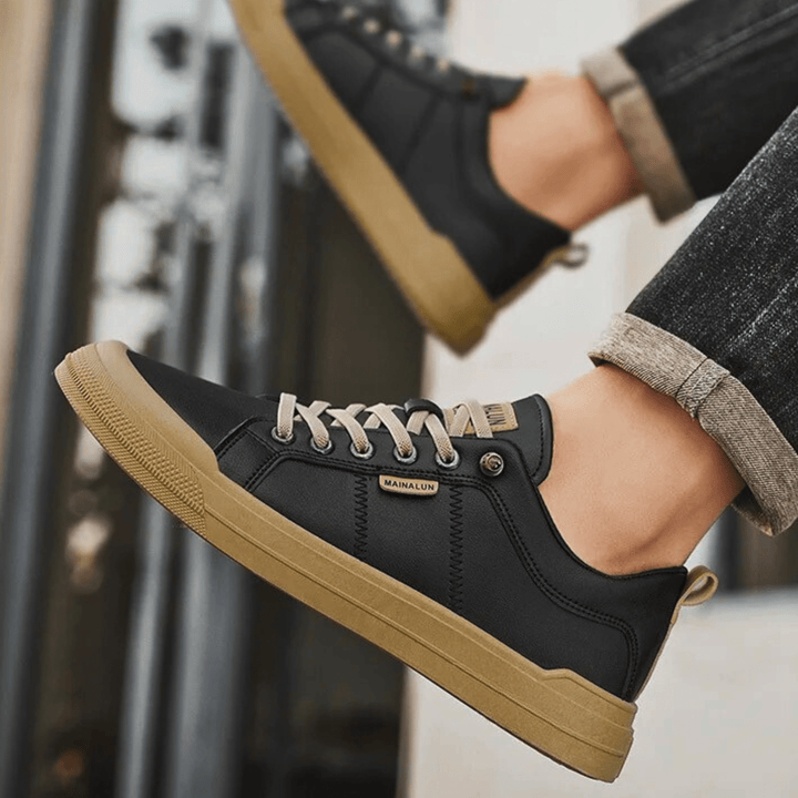 Pair of men's leather low top trainers displayed together
