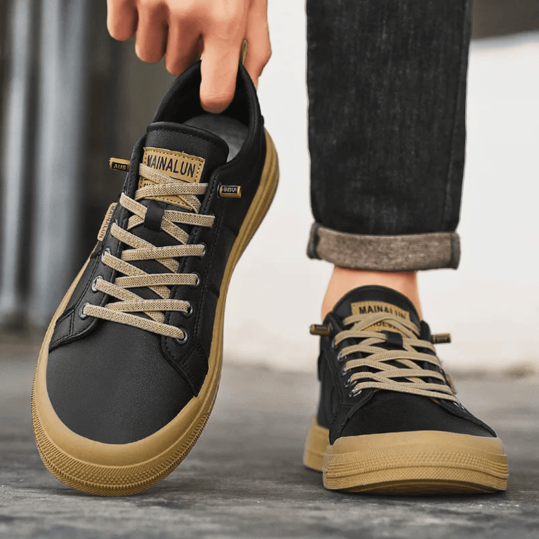 Men's leather low top trainers shown at an angled view
