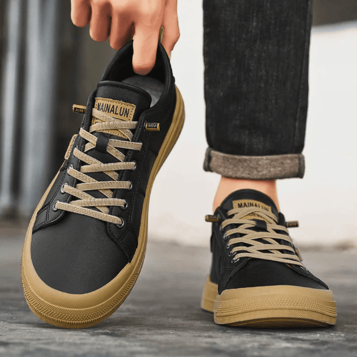 Men's leather low top trainers shown at an angled view
