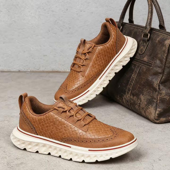 Pair of men's brogue sneakers displaying textured detailing